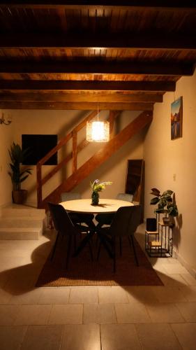 a dining room with a table and chairs at Windwood Cabin Cerro Azul in Los Altos de Cerro Azul