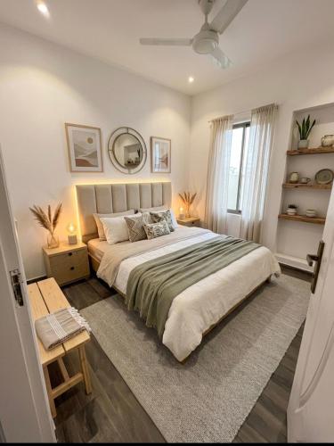 a bedroom with a large bed and a window at SM residence in Lahore