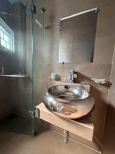 a bathroom with a bowl sink and a shower at SM residence in Lahore