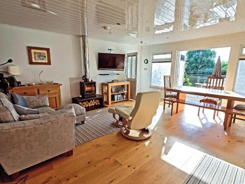 a living room with a couch and a table at Dinky Daze - Ukc7071 in Brundall