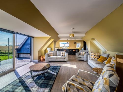 a living room with a couch and a table at Murlin in Collieston