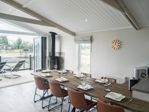 a dining room with a large wooden table and chairs at River Tees Lodge - Ukc4064 in Nunthorpe