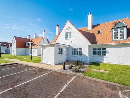 a house with a parking lot in front of it at Lundin Links - Ukc6916 in Turnberry