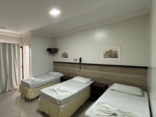 a hospital room with three beds in it at Tropical Praia Hotel in Aracaju