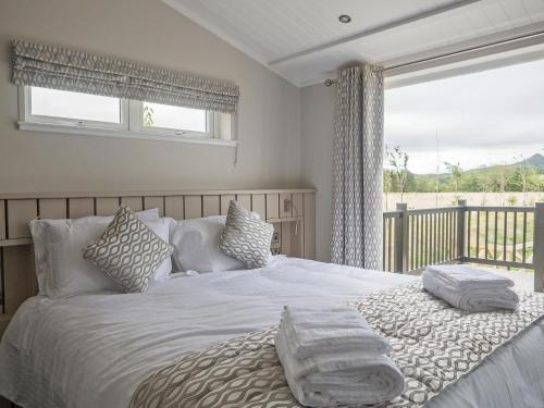 a bedroom with a bed with pillows and a window at Brian Clough Lodge - Ukc4065 in Nunthorpe