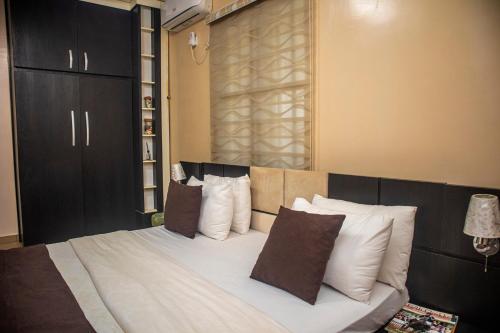a bedroom with a large bed with white pillows at #5 Apartment in Parma