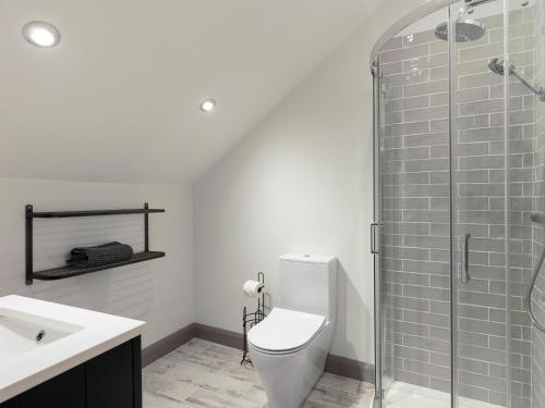 a bathroom with a toilet and a glass shower at The Foundary - Uk36319 in Whitchurch