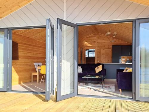 an open living room with sliding glass doors at Nature's Nook in Brundall