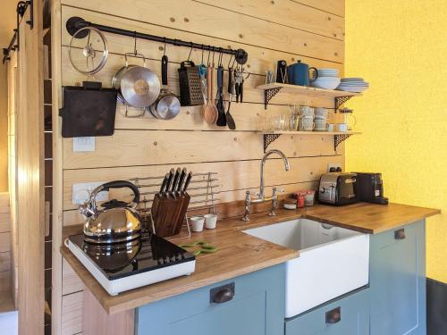 a kitchen with a sink and a counter with utensils at The Bushel - Ukc7131 in Cratfield