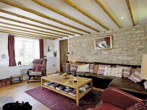 a living room with a couch and a stone wall at Limber View in Glaisdale