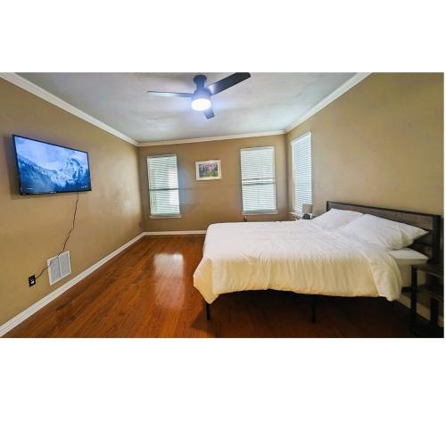 a bedroom with a bed and a ceiling fan at Elegant, comfy, a retreat with Pool in Garland