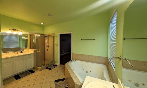 a bathroom with a tub and a toilet and a sink at Elegant, comfy, a retreat with Pool in Garland