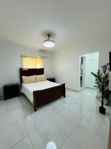 a bedroom with a bed in a white room at Luma Residence in San Felipe de Puerto Plata