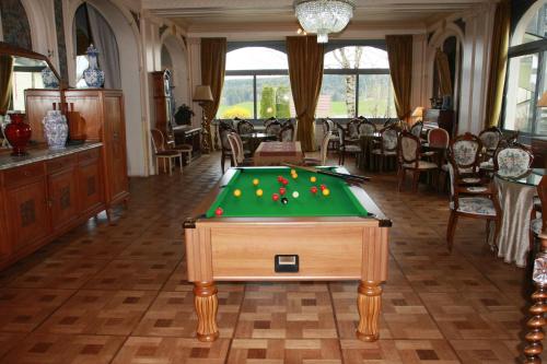 a room with a pool table with balls on it at Hôtel Beau Site in Malbuisson