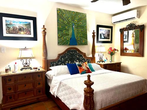 a bedroom with a bed and two night stands and two lamps at Villa Vassallo in Ponce