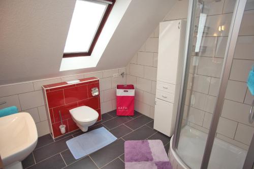 a bathroom with a toilet and a shower at Ferienhaus Victoria in Norden