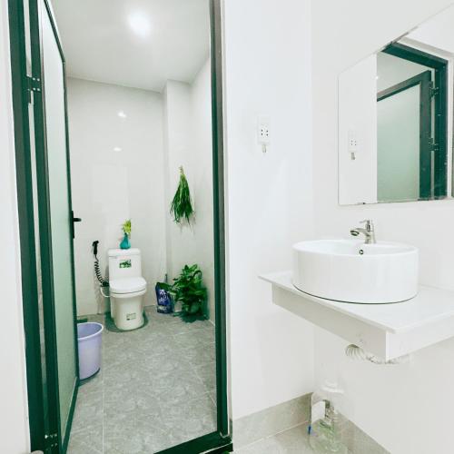 a bathroom with a sink and a mirror at La Maison de My Tho in Mỹ Tho