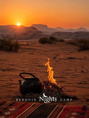 a camp fire in the desert with the sunset at Bedouin Nights Camp in Wadi Rum