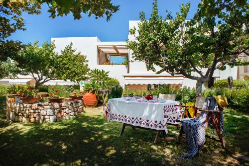 a table in the yard of a house at Nereids Apartments in Sitia