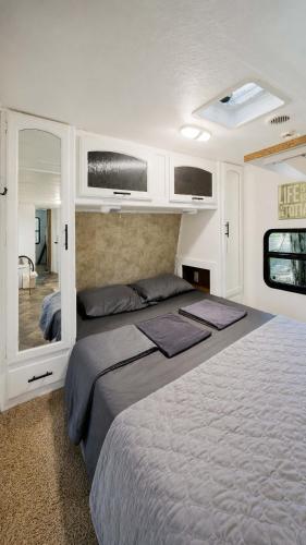 a bedroom with a large bed in a room at 2-bedroom Camper Trailer Cottage #3 in Dillon