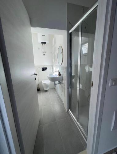a bathroom with a shower and a toilet and a sink at Casa-Torre Normanna in Bitonto