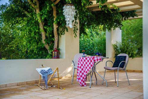 a table and chairs sitting on a patio at Nereids Apartments in Sitia