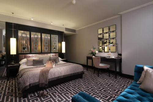 a hotel room with a large bed and a large mirror at The Fitzwilliam Hotel Belfast in Belfast
