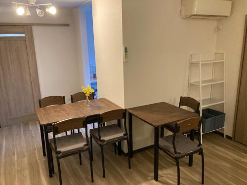 a dining room with a table and chairs in a room at Osaka Convenient Location Entire Private Second Floor in Hirakata
