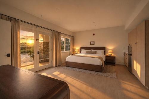 a bedroom with a bed and a large window at Bella Notte by the Beach in Santa Cruz