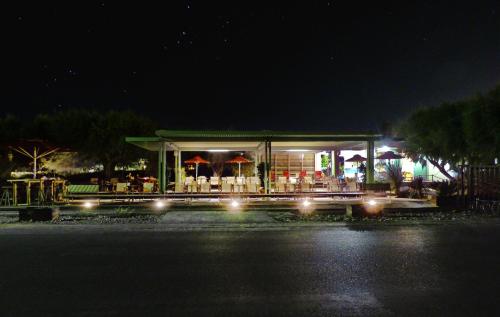 a gas station at night with lights at Nereids Apartments in Sitia