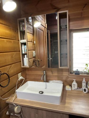 a bathroom with a sink and a mirror at Based Inn Okayama Kurashiki in Okayama