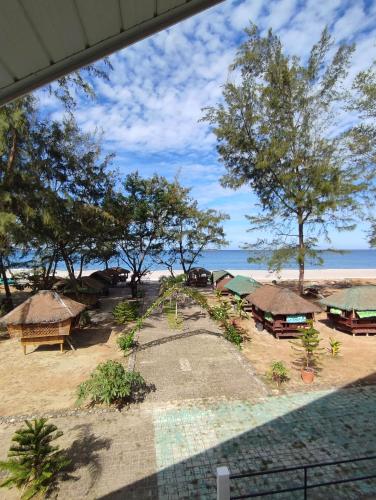 a view of a resort with trees and a beach at Villa Loreta Beach Resort in Zambales