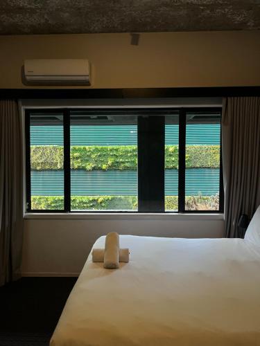 a bedroom with a bed and a large window at Sandton CBD apartment in Johannesburg