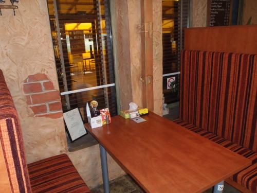 a wooden table and chairs in a room at Geltona in Šiauliai