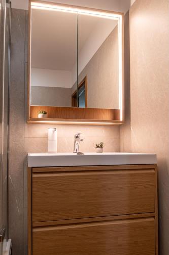 a bathroom with a sink and a mirror at B&B Villa Marta - New Opening 2026 in Medulin