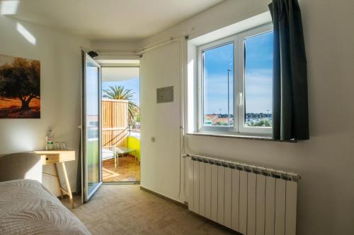a bedroom with a bed and a window at B&B Villa Marta - New Opening 2026 in Medulin