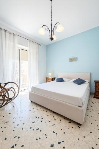 a bedroom with a large white bed and a window at Al Centro - Gaeta in Gaeta