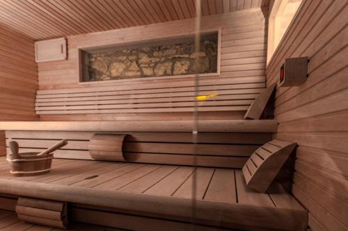 a sauna with a bench in a wooden room at Boutique Hotel Annuska in Balatonfüred