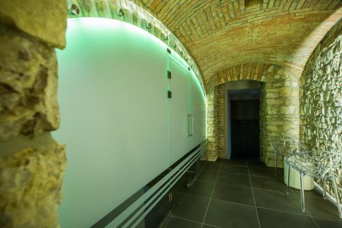 a hallway in a building with a brick wall at Boutique Hotel Annuska in Balatonfüred