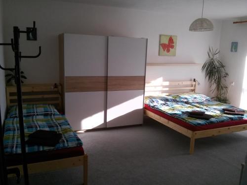a bedroom with a bed and a cabinet in it at Apartmán Žďár in Žďár nad Sázavou