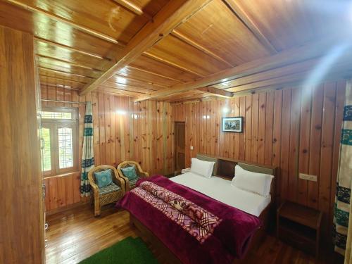 a bedroom with a bed in a wooden room at Himalaya Vista - 1km Uphill Hike from Main Road in Harsil