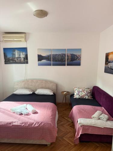 a room with two beds and a couch at Apartman Dunjićeva in Kotor