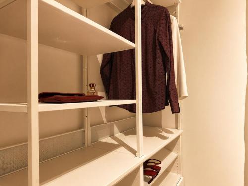 a walk in closet with white shelving at iPrincipati Luxury Living Suite in Salerno