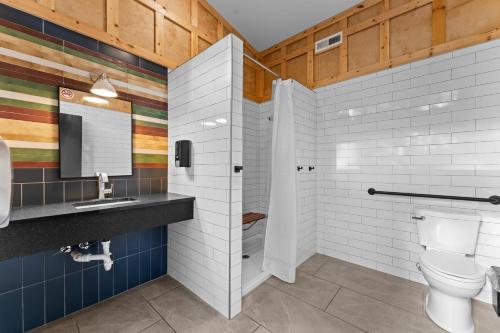 a bathroom with a toilet and a sink and a mirror at Chic Glamping Tent with Firepit in Branson