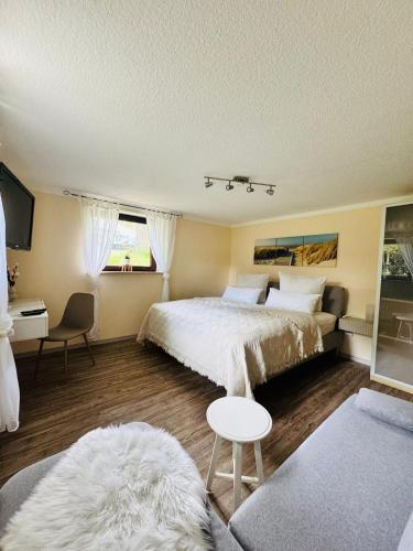 a bedroom with a large bed and a couch at Auszeit am Petersdorfer See in Funfseen
