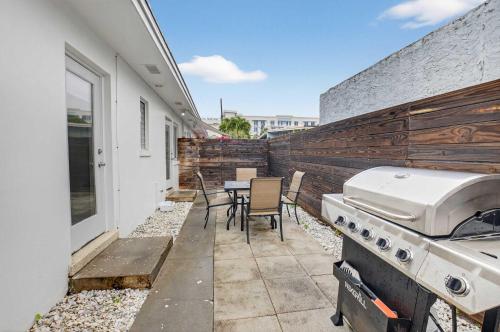 a patio with a grill and a table and chairs at Marina Row 4 Beach Shops in Delray Beach