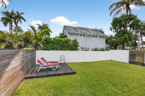 a yard with two chairs and a fence at Marina Row 4 Beach Shops in Delray Beach