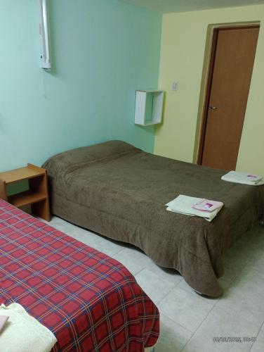 a room with two beds in a hotel room at Hospedaje DON MANUEL in Paso de Indios