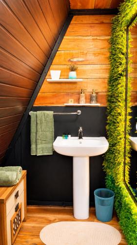 a bathroom with a white sink in a house at Ora sigiriya Cabana in Sigiriya