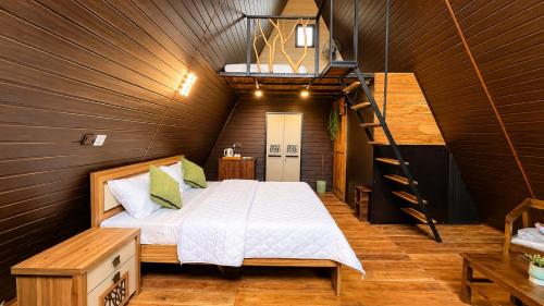a bedroom with a bed and a ladder at Ora sigiriya Cabana in Sigiriya